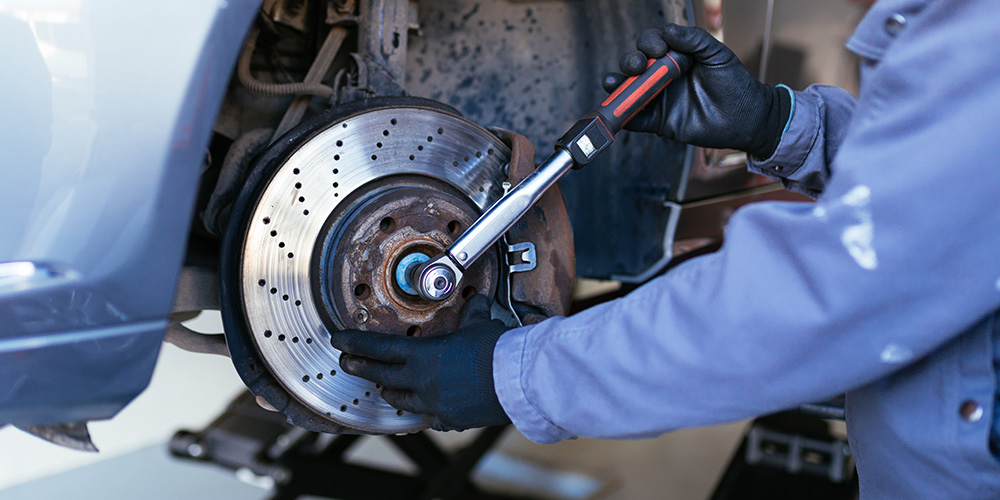 Photo Of Mechanic Fixing Brake